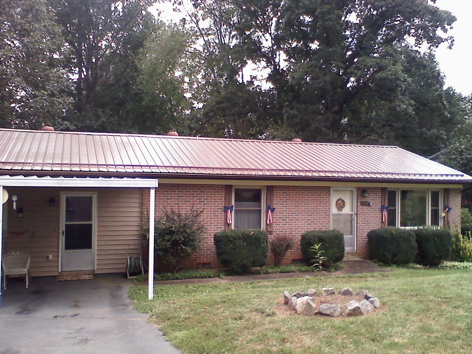 Bronze metal roof and carport on a brick ranch home — Roof Repair work by our crew in Union Grove